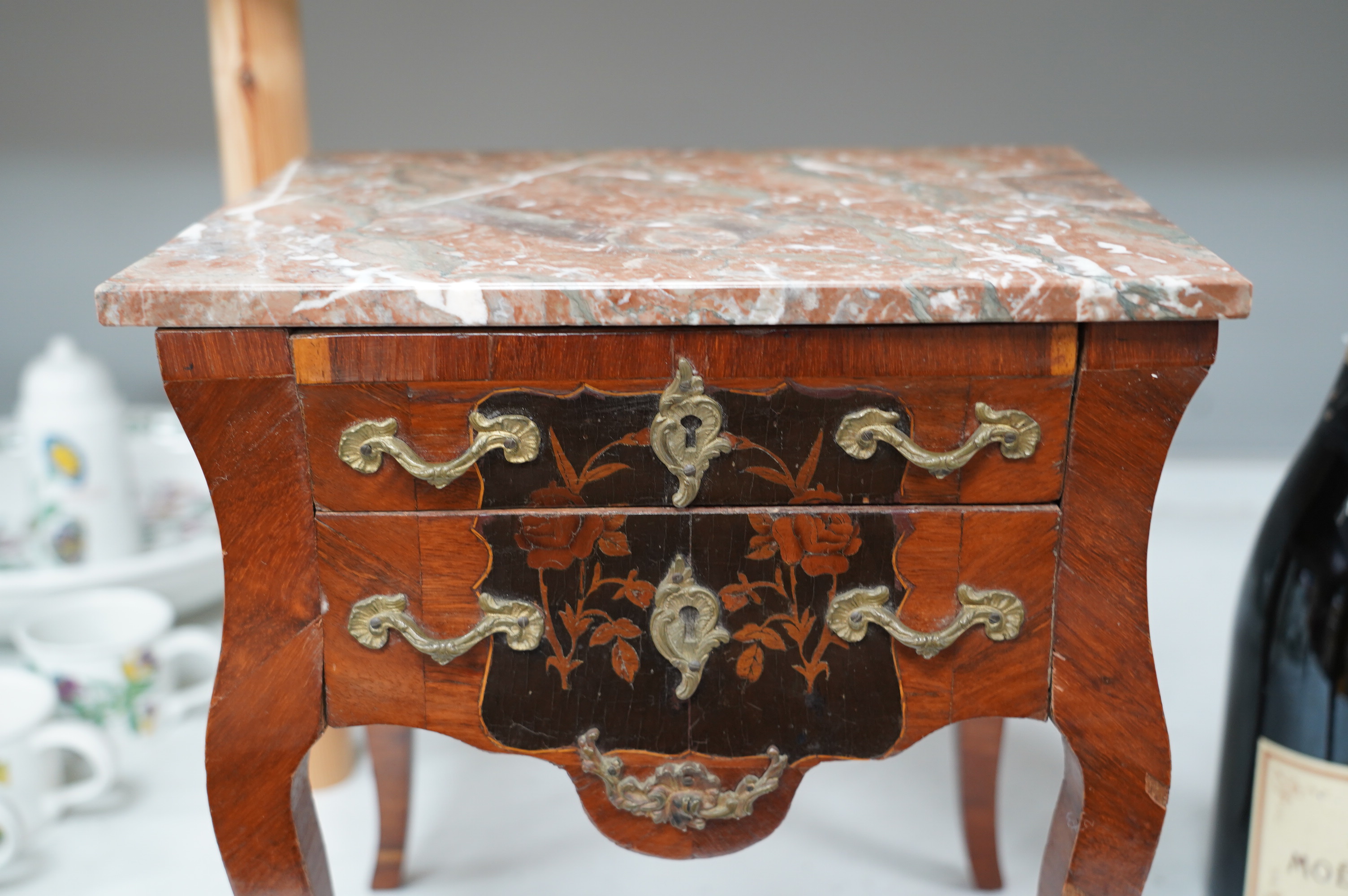 A 19th century French miniature kingwood and marquetry chest, marble topped, 35.5cm high. Condition - fair, some minor damage and losses to veneer etc.